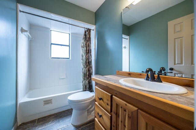 full bathroom with shower / tub combo with curtain, vanity, and toilet