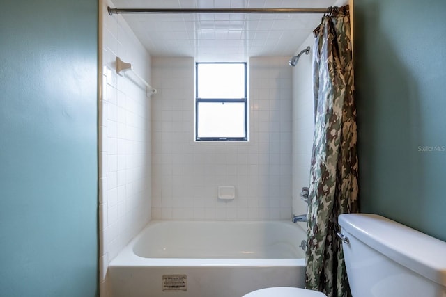 full bathroom with shower / bath combo with shower curtain and toilet