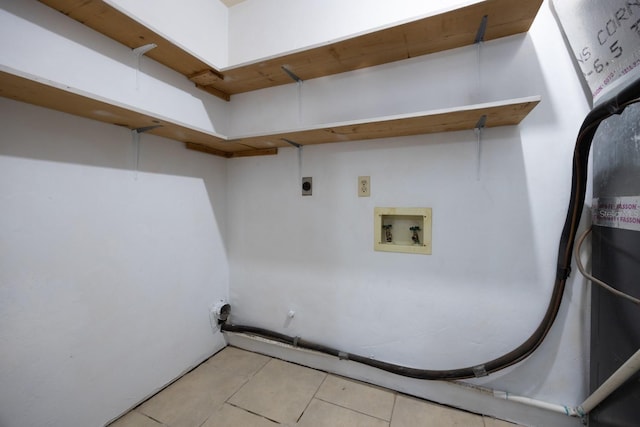 laundry area with laundry area, washer hookup, hookup for an electric dryer, and light tile patterned flooring