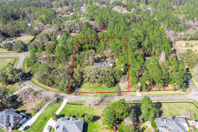 birds eye view of property featuring a view of trees