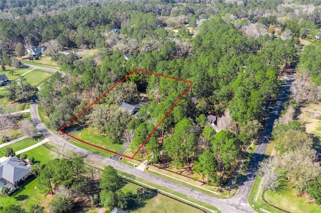 bird's eye view featuring a wooded view