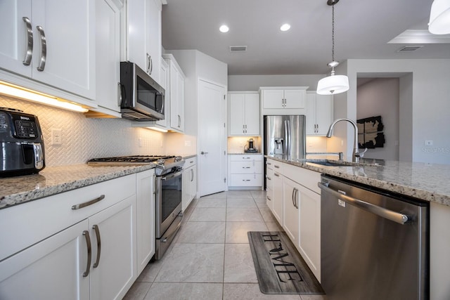 kitchen with visible vents, white cabinets, stainless steel appliances, and a sink