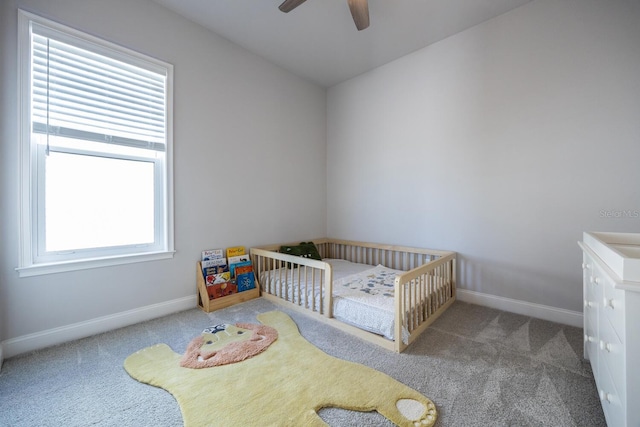 carpeted bedroom featuring a ceiling fan and baseboards