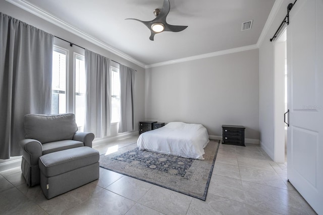 bedroom featuring a barn door, baseboards, visible vents, and crown molding