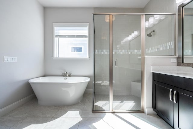 full bath with a shower stall, a freestanding bath, vanity, and baseboards