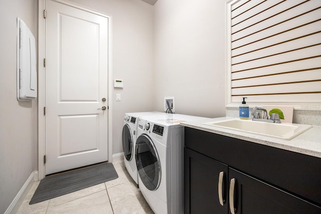 laundry room featuring baseboards, electric panel, separate washer and dryer, cabinet space, and a sink