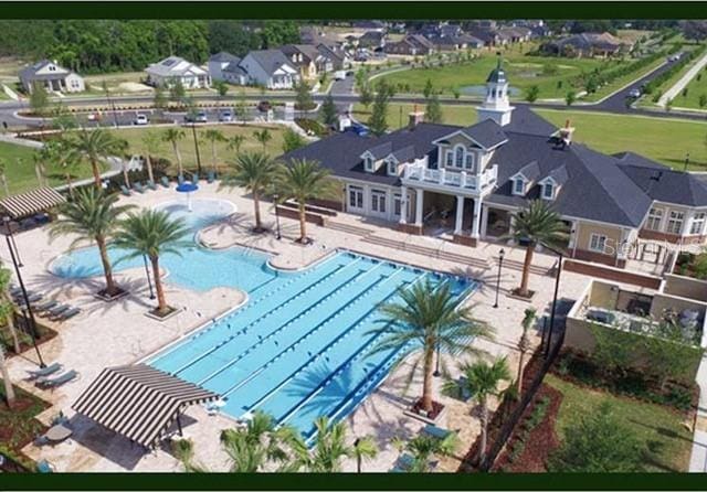 pool with a residential view and a patio