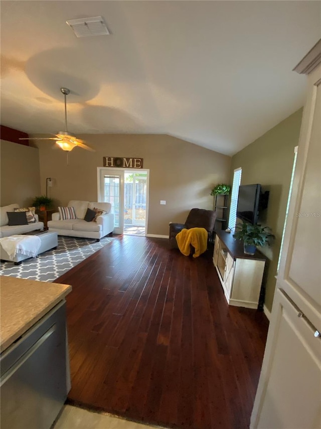 living room with visible vents, wood finished floors, and vaulted ceiling