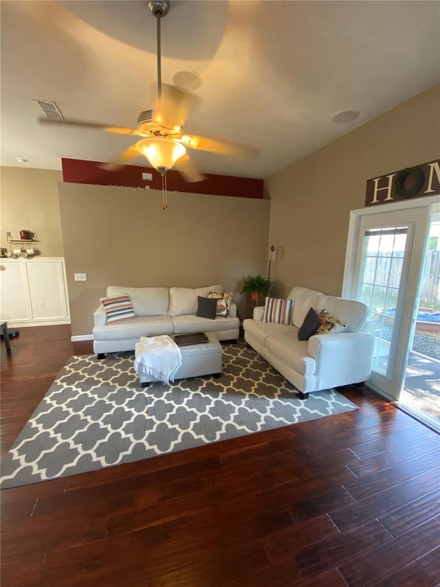 unfurnished living room with lofted ceiling, wood finished floors, visible vents, and ceiling fan