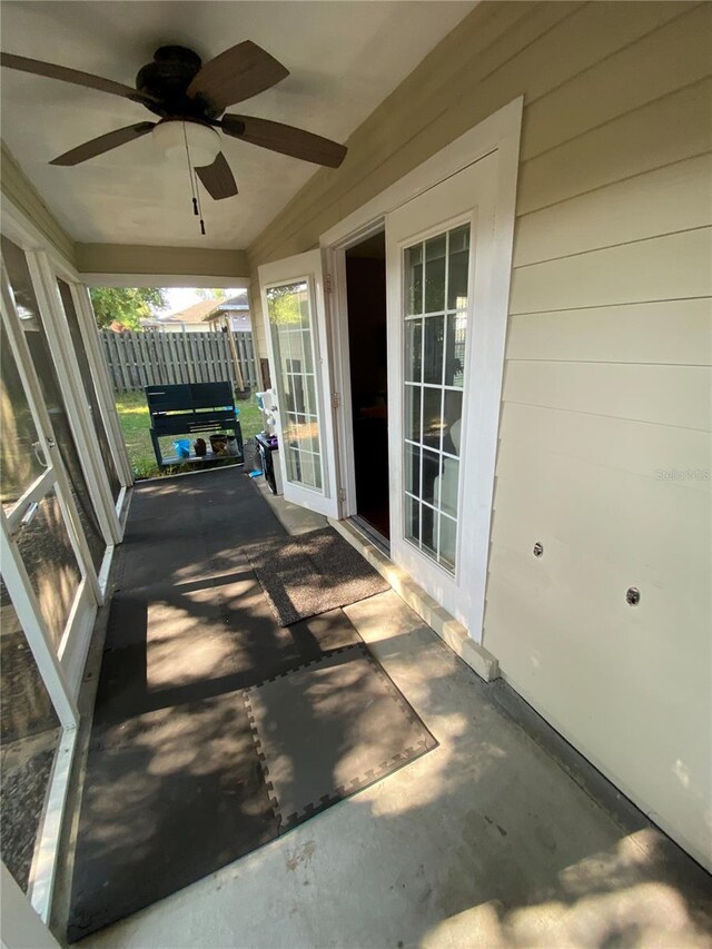 view of patio with a ceiling fan and fence