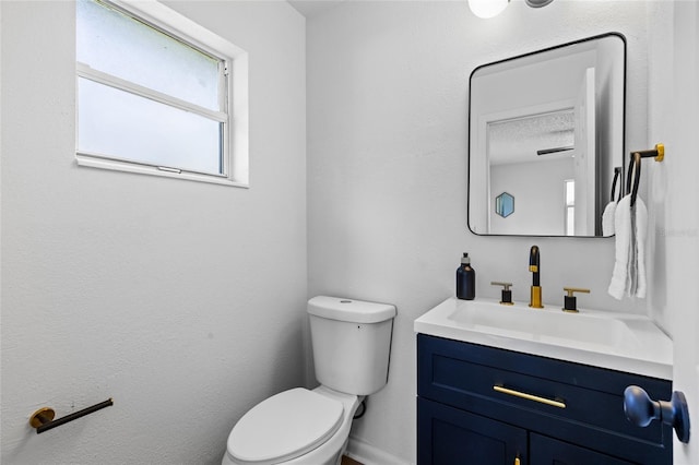 bathroom featuring toilet and vanity