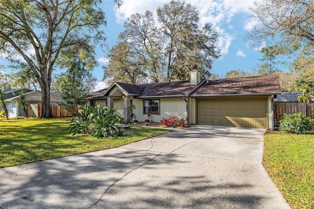 ranch-style home featuring a chimney, concrete driveway, a front yard, and fence