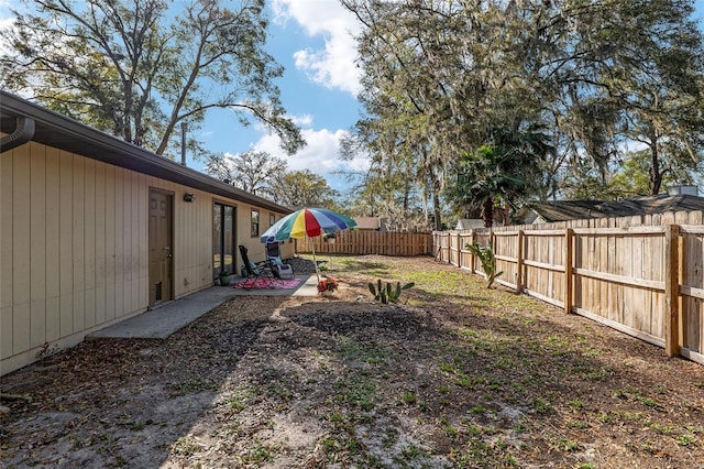 view of yard featuring a patio area and a fenced backyard