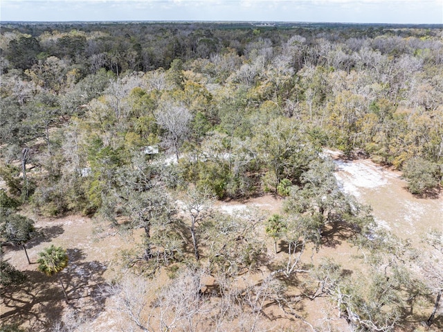 birds eye view of property featuring a wooded view