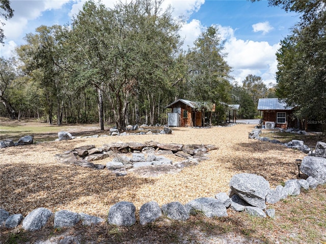 view of yard featuring a shed and an outbuilding