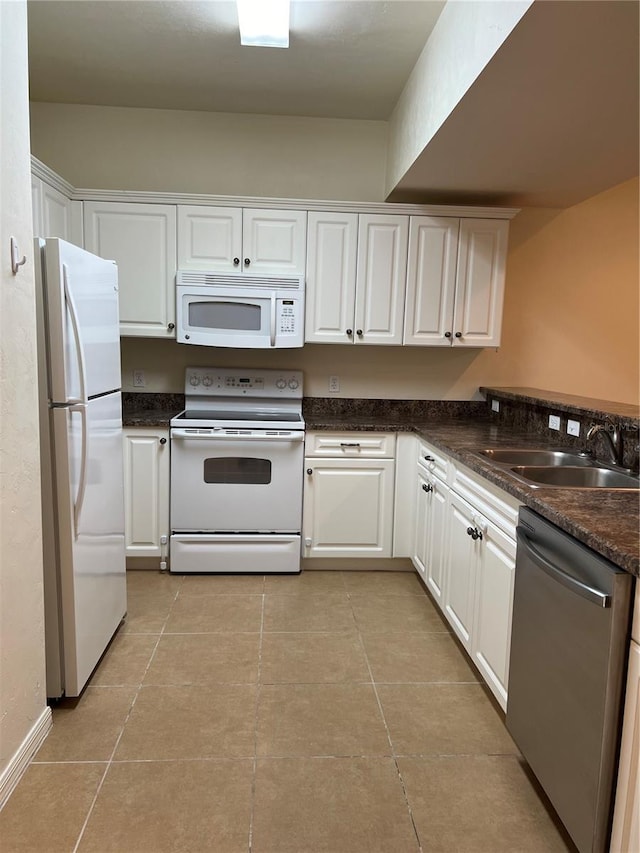 kitchen featuring white appliances, white cabinetry, and a sink