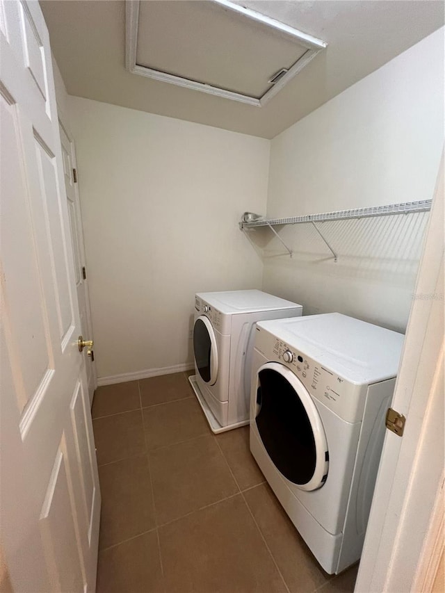 clothes washing area with laundry area, attic access, baseboards, tile patterned flooring, and separate washer and dryer