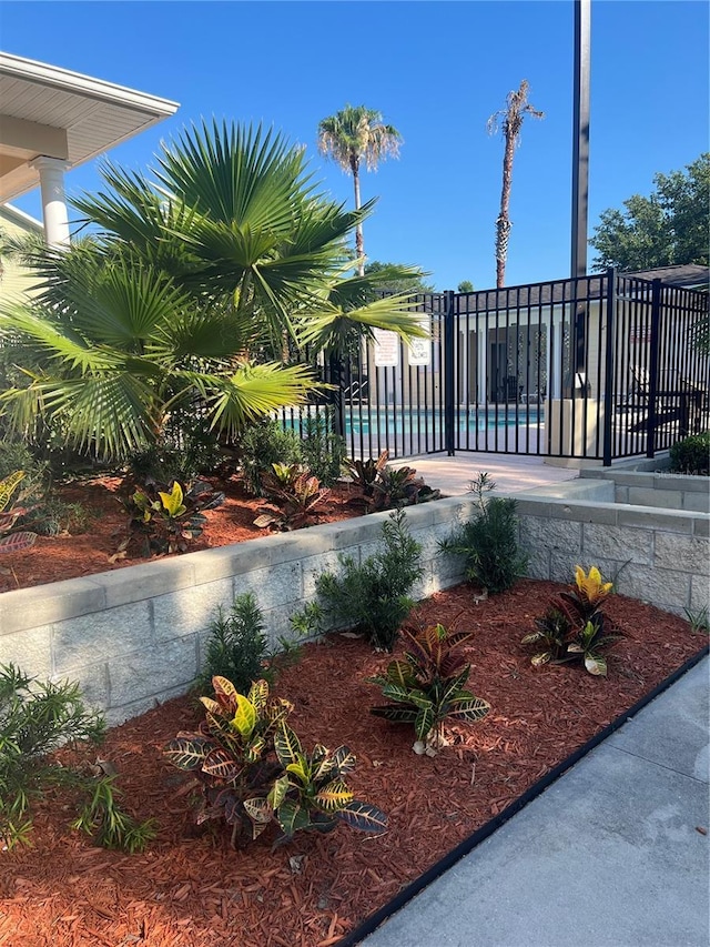 exterior space with fence and a pool