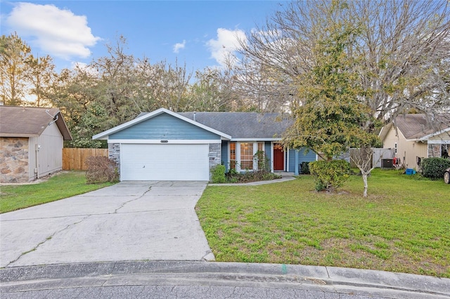 ranch-style home with a front lawn, fence, driveway, stone siding, and an attached garage