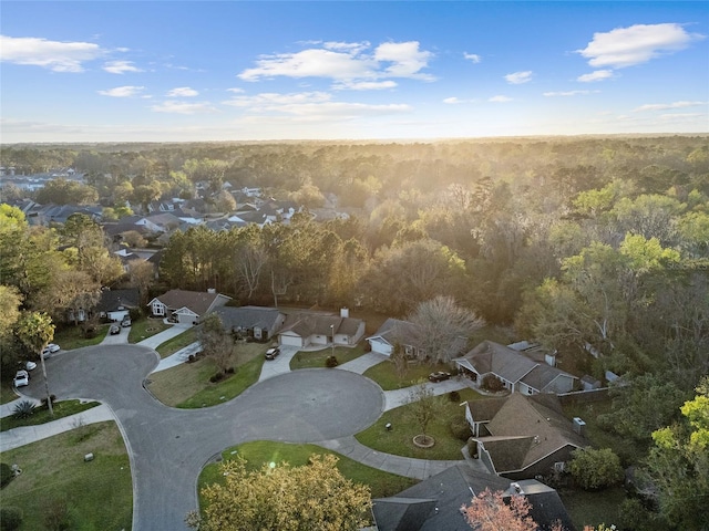 birds eye view of property with a view of trees