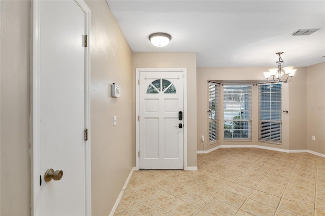 entrance foyer featuring light tile patterned floors, visible vents, and baseboards