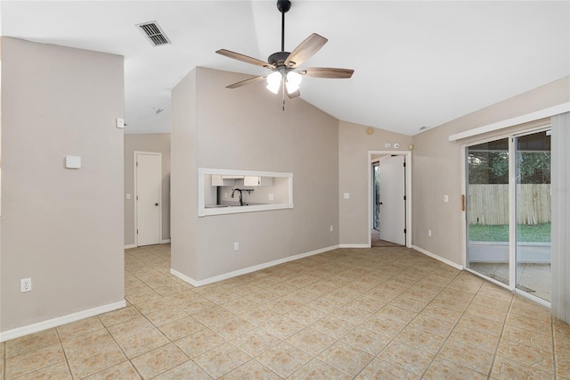 empty room with visible vents, baseboards, vaulted ceiling, tile patterned floors, and a ceiling fan