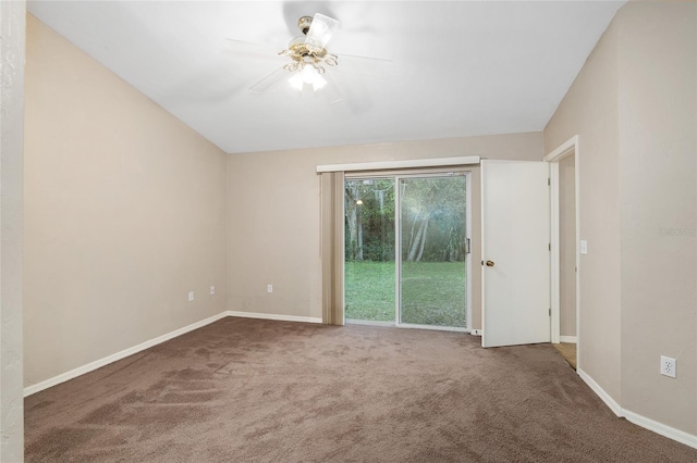 carpeted empty room with ceiling fan and baseboards