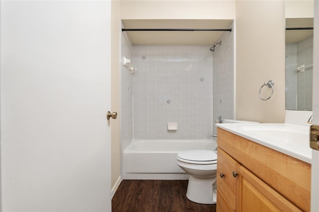 full bathroom featuring toilet, wood finished floors, vanity, baseboards, and shower / bathtub combination