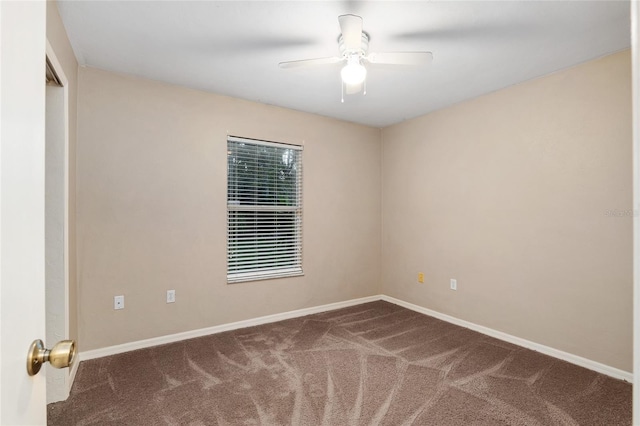 spare room with baseboards, ceiling fan, and carpet flooring