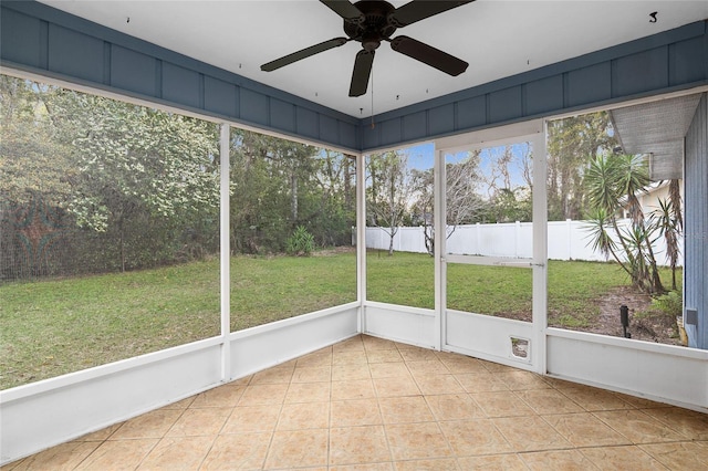 unfurnished sunroom with a ceiling fan