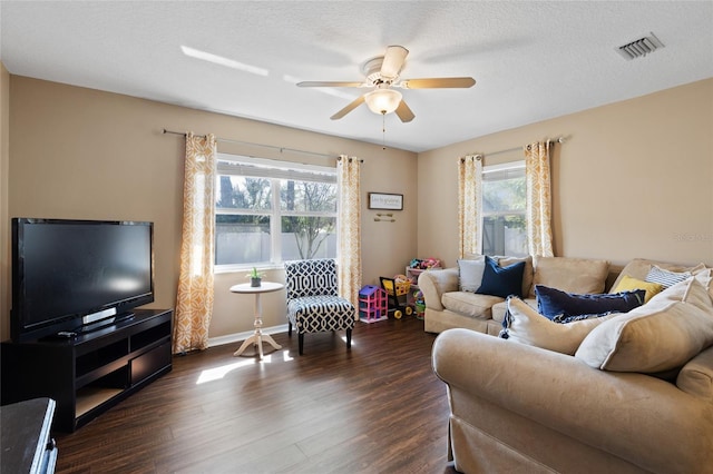 1762 NE 39th St, Ocala, FL 34479 - living area with baseboards, visible vents, ceiling fan, dark wood-style flooring, and a textured ceiling
