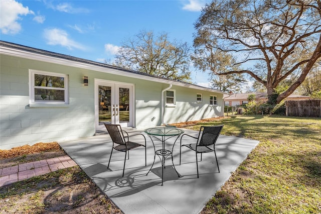 view of patio / terrace featuring fence and french doors