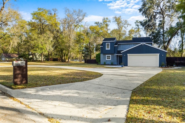 view of front of house featuring driveway, an attached garage, and a front yard