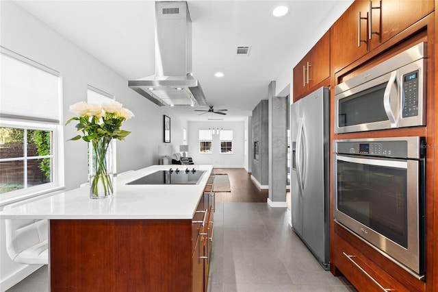 kitchen with an island with sink, open floor plan, light countertops, stainless steel appliances, and ventilation hood