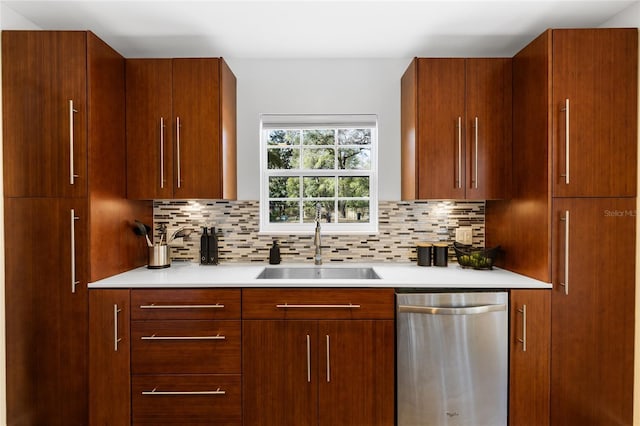 kitchen with decorative backsplash, light countertops, a sink, and stainless steel dishwasher