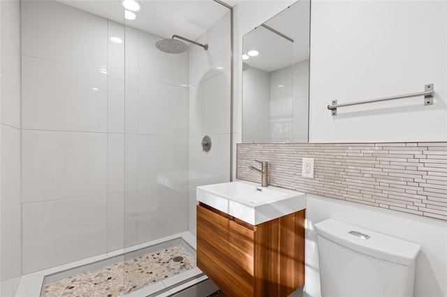 full bath with tile walls, backsplash, toilet, vanity, and tiled shower