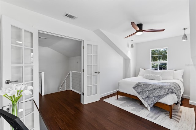 bedroom featuring ceiling fan, wood finished floors, visible vents, and baseboards