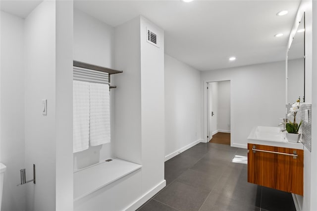 bathroom with recessed lighting, a sink, visible vents, baseboards, and double vanity