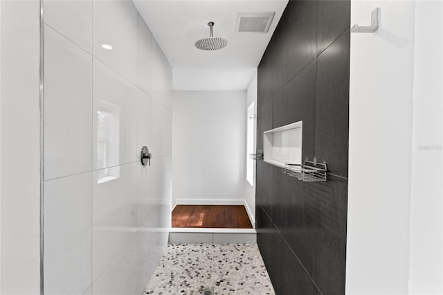 hallway with visible vents and baseboards