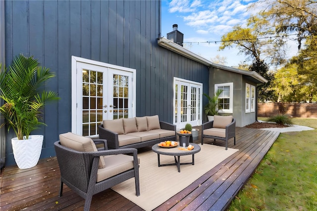 wooden terrace featuring french doors, outdoor lounge area, and fence