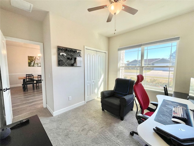 carpeted home office featuring ceiling fan and baseboards