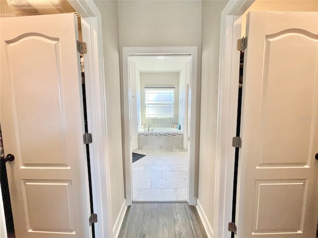 hallway with wood finished floors