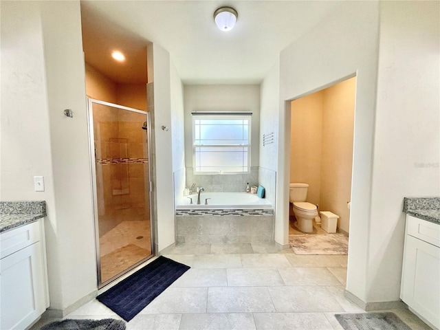 bathroom with a bath, toilet, a stall shower, and vanity