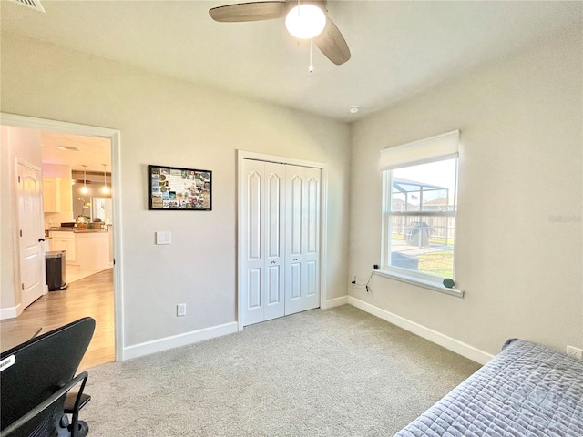 bedroom featuring carpet floors, a closet, a ceiling fan, and baseboards