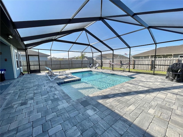 view of pool with a fenced in pool, a patio area, a fenced backyard, and a lanai