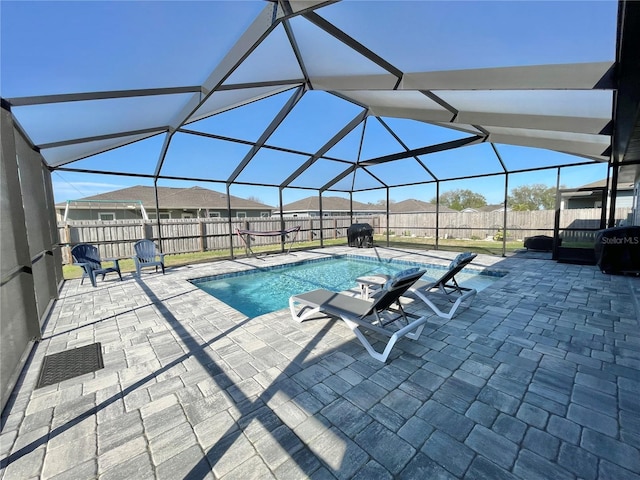 view of pool with a lanai, a fenced backyard, a fenced in pool, and a patio