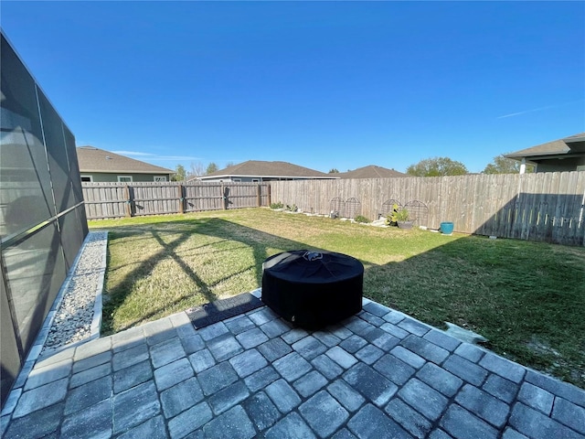 view of yard featuring a patio area, a fenced backyard, and a lanai