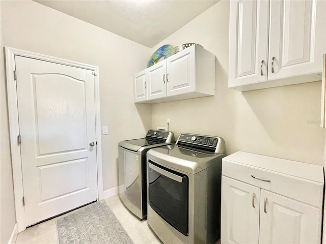 laundry area with separate washer and dryer, cabinet space, and baseboards