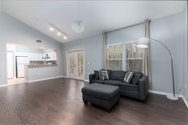 living room featuring dark wood-type flooring, french doors, visible vents, and baseboards