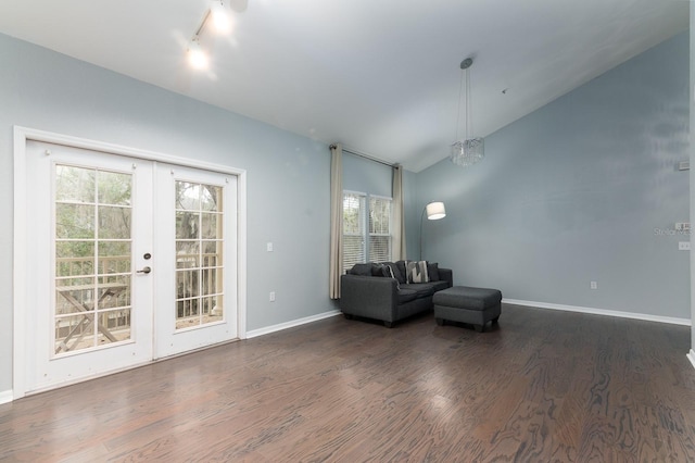 unfurnished room featuring lofted ceiling, french doors, baseboards, and wood finished floors